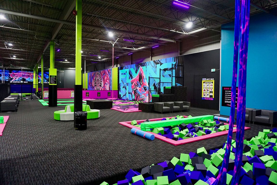 Aerial silks over a foam pit.