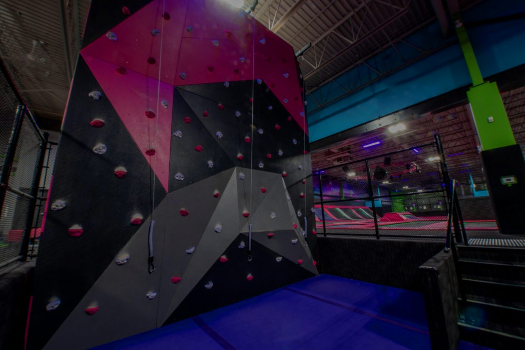 Shock climbing wall attraction