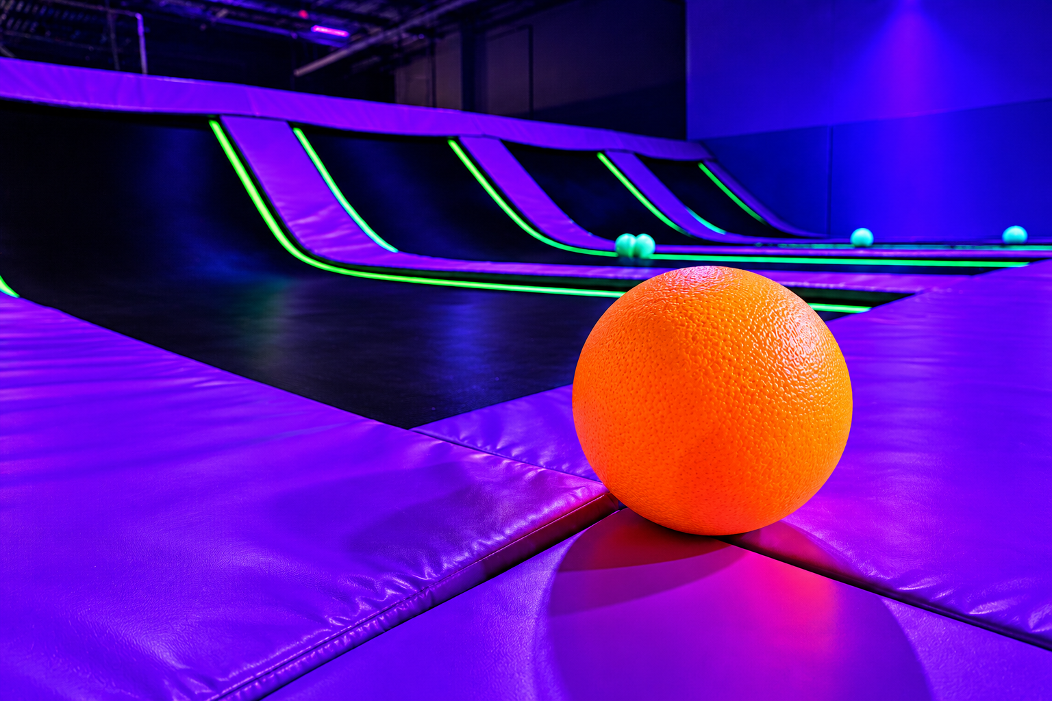 Standard trampoline dodgeball court with UV-reactive pads and mat webbing glowing under blacklight