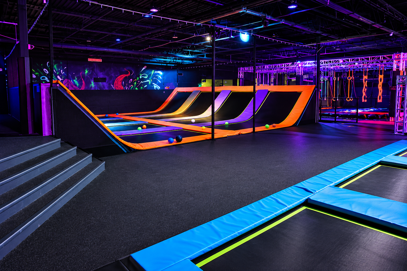 Trampoline dodgeball court with UV-reactive pads under blacklight