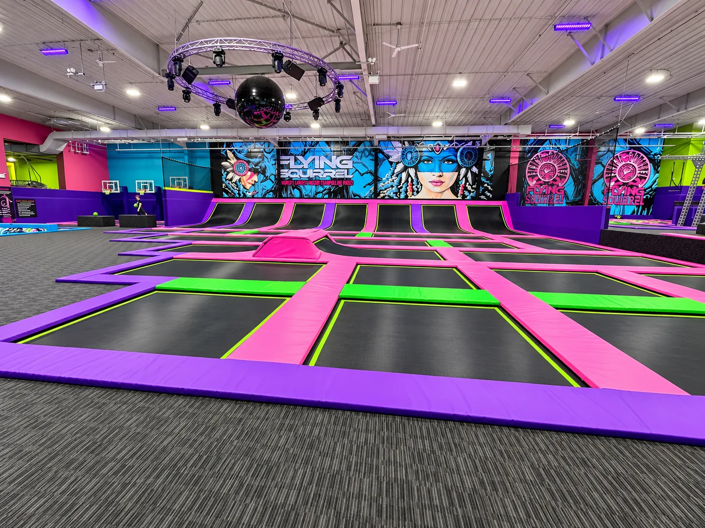 Flying Squirrel freestyle court with angled wall ramps and purple and pink pads